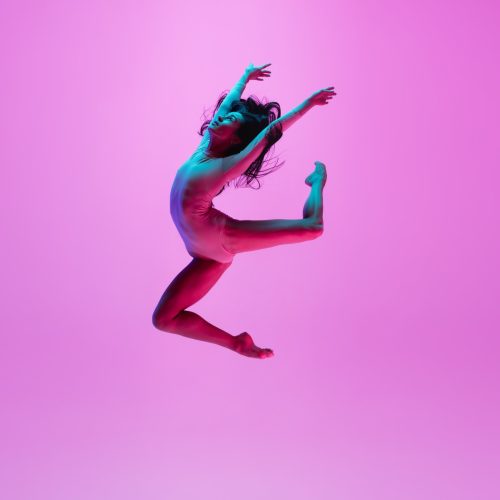 young-girl-jumping-pink-wall