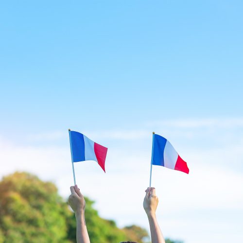 hand-holding-france-flag-blue-sky-background-holiday-french-national-day-bastille-day-happy-celebration-concepts